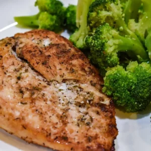 Grilled chicken breast with steamed broccoli on a plate. One-Pan Garlic Parmesan Chicken